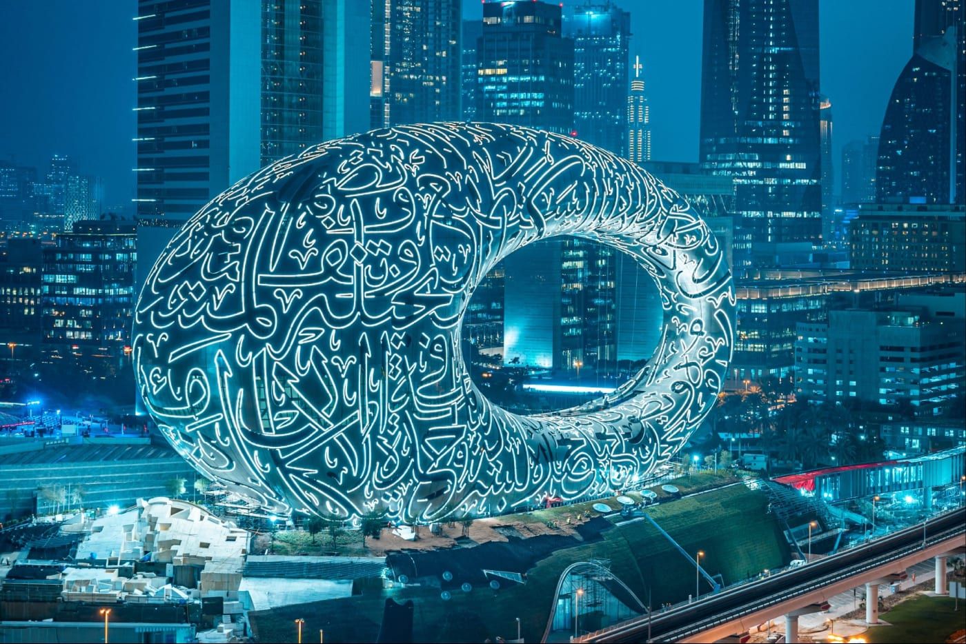 The Museum of the Future at night, its calligraphy facade lit up