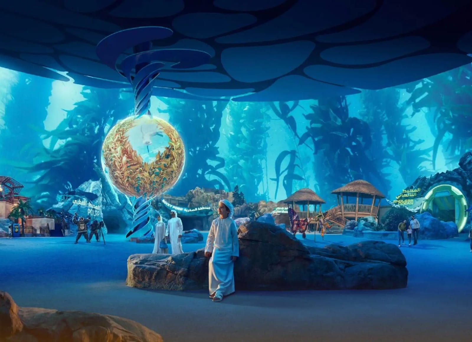 A diver beside the giant globe inside the SeaWorld aquarium